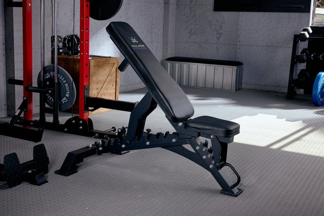 Black adjustable bench positioned in a home gym setting.