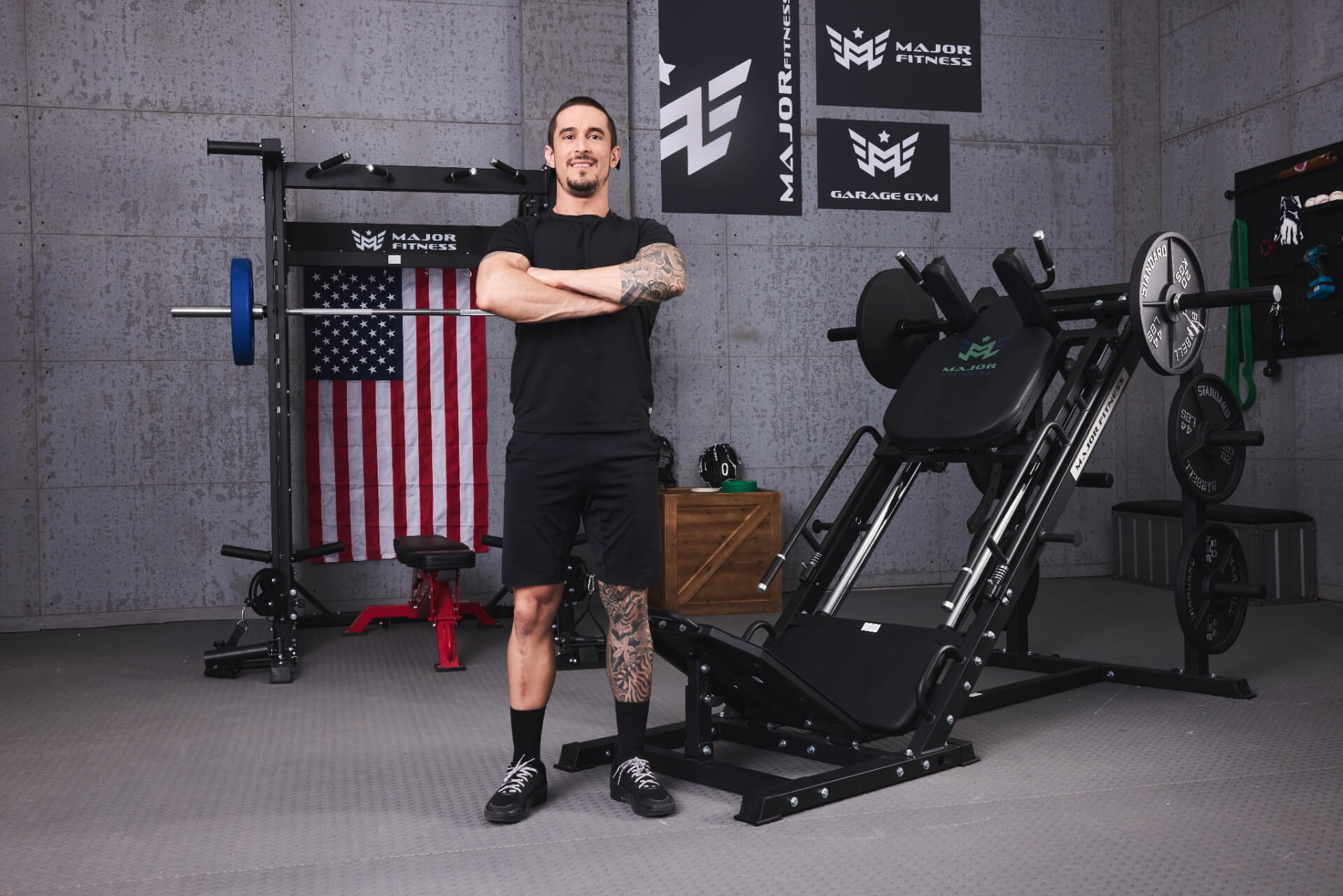 A male standing in front of a Major Fitness Smith machine and leg press hack squat machine