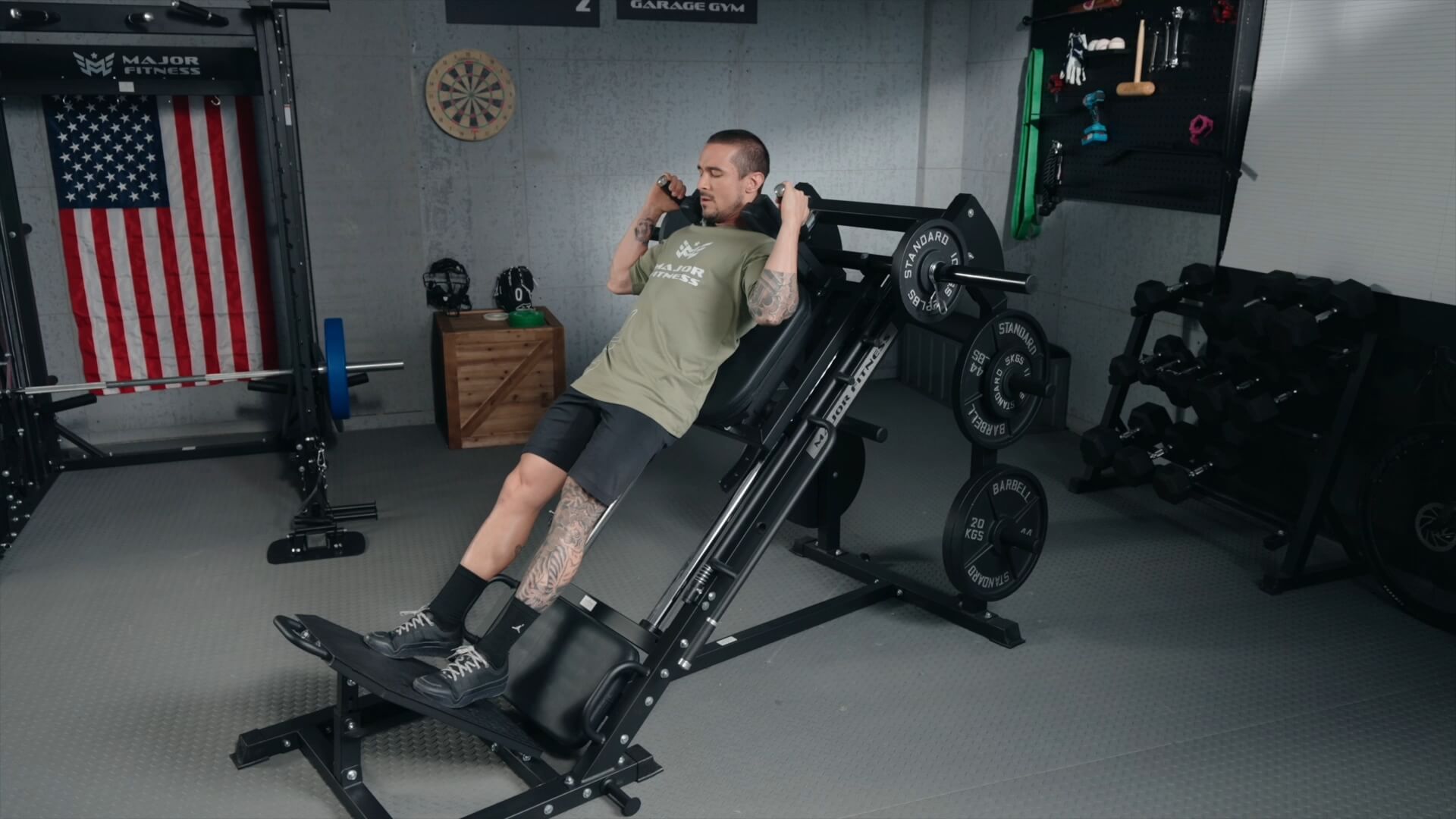 Man performing a calf raise exercise on a Major Fitness leg press hack squat machine