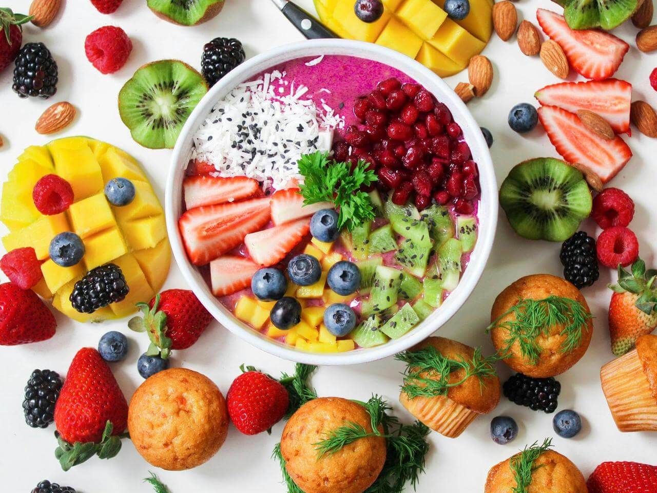 vibrant fruit bowl with berries and nutritious muffins