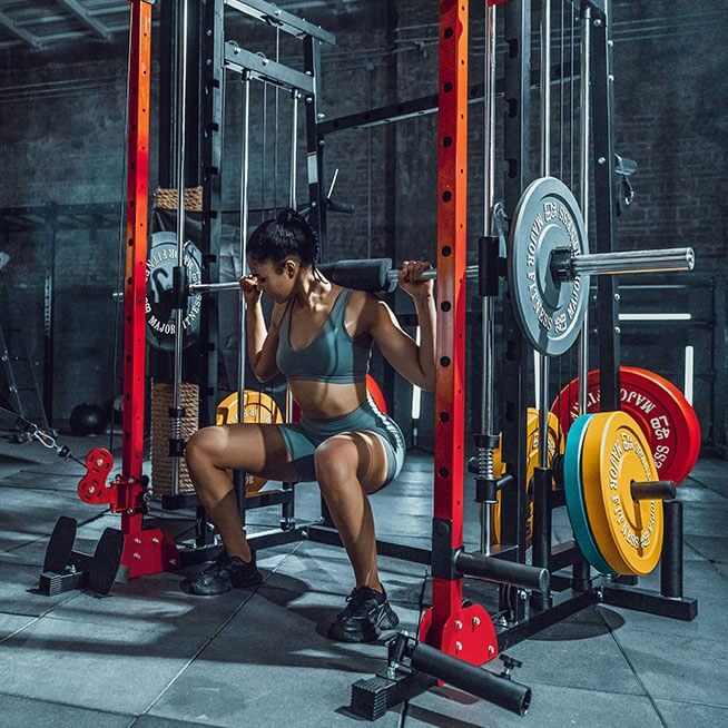 a woman squatting at a home gym