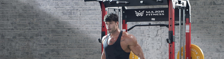 Upper body picture of a man standing in front of a power rack