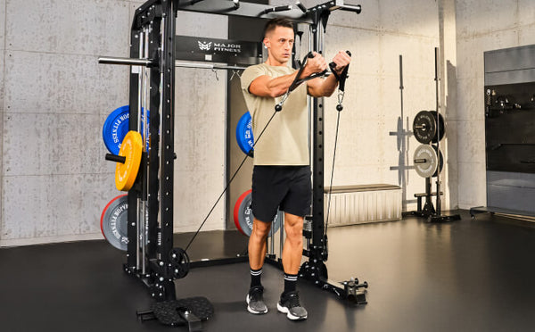 man using a cable pulley system on a smith machine in a home gym setup